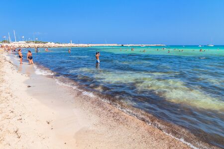 SAN VITO LO CAPO, ITALY - AUGUST 22, 2014: tourists and locals enjoy blue mediterranean sea in San Vito Lo Capo, Italy. This small town is located in a valley between spectacular mountains, and its famous beach has been elected best italian beach on TripAのeditorial素材