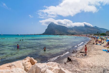 SAN VITO LO CAPO, ITALY - AUGUST 22, 2014: tourists and locals enjoy blue mediterranean sea in San Vito Lo Capo, Italy. This small town is located in a valley between spectacular mountains, and its famous beach has been elected best italian beach on TripAのeditorial素材