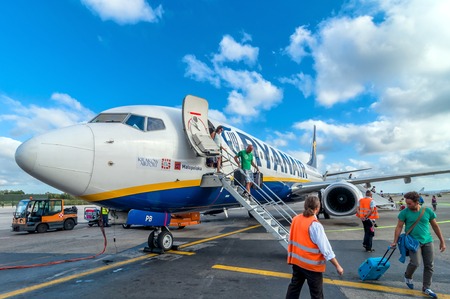 PISA, ITALY - AUGUST 21, 2014: passengers deplane Ryanair Jet airplane after landing in Pisa airport, Italy. Ryanair is the biggest low-cost airline company in the world.のeditorial素材