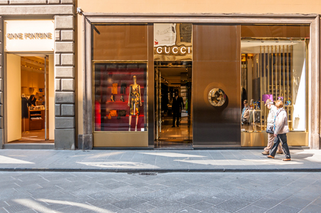 FLORENCE, ITALY - March 21, 2014: tourists walk in front of Gucci Shop in Florence, Italy. Florence is home to some of the most famous works of art on earth.のeditorial素材