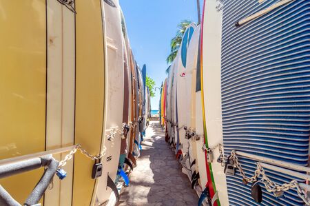Honolulu, HI, USA - September 7, 2013: Surfboards lined up in the rack at famous Waikiki Beach in Honolulu. Oahu, Hawaii.のeditorial素材
