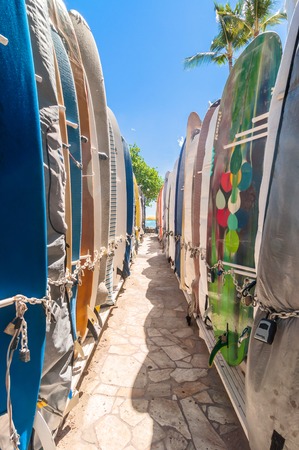 Honolulu, HI, USA - September 7, 2013: Surfboards lined up in the rack at famous Waikiki Beach in Honolulu. Oahu, Hawaii.のeditorial素材