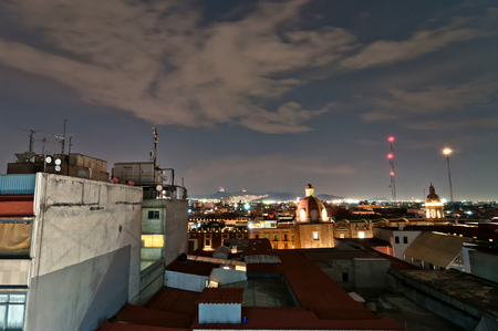 Mexico City, Mexico - April 29, 2014: night view of skyline with brightly lit suburban barrios in the background in Mexico City, Mexico. The city is located at an altitude of 2,240 metres.のeditorial素材