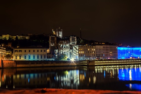 LYON FRANCE  DECEMBER 6 2014: street view with city skyline reflected in river during Festival of Lights in Lyon France. The origins of the Fete des Lumieres date to 1643.のeditorial素材