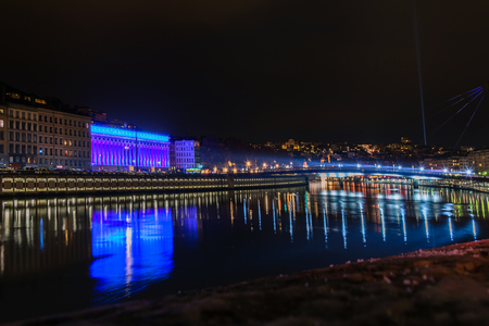 LYON FRANCE  DECEMBER 6 2014: street view with city skyline reflected in river during Festival of Lights in Lyon France. The origins of the Fete des Lumieres date to 1643.のeditorial素材