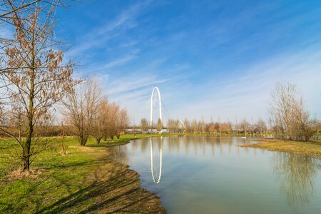 REGGIO EMILIA, ITALY - MARCH 9, 2015: bridges complex by architect Santiago Calatrava reflected in pound in Reggio Emilia, Italy. The central arch of the bridge is 220 meters long and 50 meters highのeditorial素材