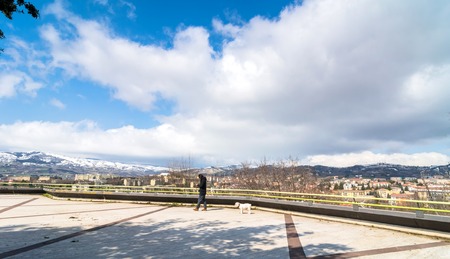 POTENZA, ITALY - MARCH 13, 2015: unidentified person with dog, panoramic view of city and mountains in Potenza, Italy. Potenza is the highest regional capital city in Italy.のeditorial素材