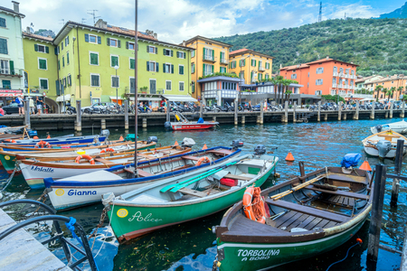 Torbole, Italy - August 2, 2015: Lake Garda boardwalk with houses, tourists and boats in Torbole, Italy. Torbole is one of the most popular towns on Garda Lake, known as a wind surfers paradise.のeditorial素材