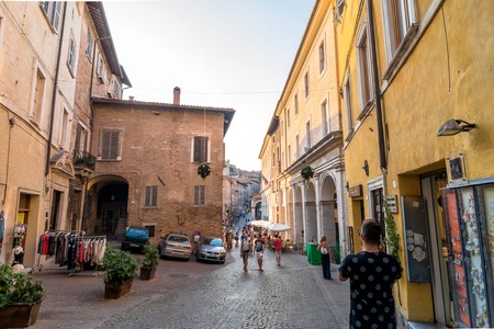 Urbino, Italy - August 13, 2015: street view with tourists in Urbino, Italy. The historic center of Urbino was declared  represents the zenith of Renaissance art and architecture.のeditorial素材