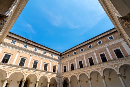 Urbino, Italy - August 14, 2015: Ducal Palace courtyard with tourists in Urbino, Italy.のeditorial素材