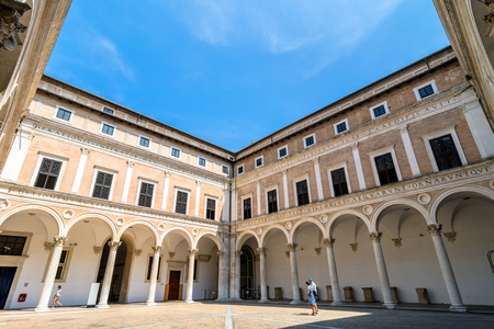 Urbino, Italy - August 14, 2015: Ducal Palace courtyard with tourists in Urbino, Italy.のeditorial素材