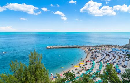 Sirolo, Italy - August 17, 2016: day view of famous beach crowded with tourists in Sirolo, Italy. Mount Conero Natural Reserve Regional Park is a unique ecological environment.のeditorial素材