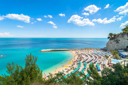 Sirolo, Italy - August 17, 2016: day view of famous beach crowded with tourists in Sirolo, Italy. Mount Conero Natural Reserve Regional Park is a unique ecological environment.のeditorial素材
