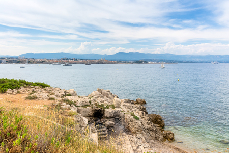 Antibes, France - June 29, 2016: view over the bay with old town skyline and alpes maritimes from Cap d'Antibes, Antibes. Antibes is a popular seaside town in the heart of the Cote d'Azurのeditorial素材