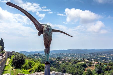 Saint Paul de Vence, France - June 30, 2016: day view of typical street with statue and panoramic view in Saint Paul de Vence, France. It is popular destination for a large number of artists, poets and writers.のeditorial素材