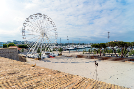 Antibes, France - July 01, 2016: Modern art sculptures and grande roue on the Pre-des-Pecheurs esplanade in the old town. The area was renovated in 2014 and is popular for events.のeditorial素材