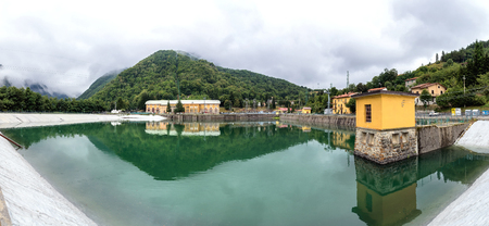 landscape with hydroelectric power plant and lake long exposure in Ligonchio, Emilia Apennines, Italyの写真素材