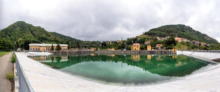 landscape with hydroelectric power plant and lake long exposure in Ligonchio, Emilia Apennines, Italyの写真素材
