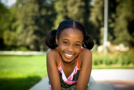 young african american girl smiling in the shadeの写真素材