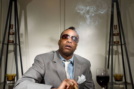 a stylish african american smoking his cigaの写真素材