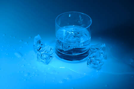Water in the glass on blue backgroundの写真素材