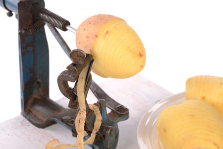 original old maschine apple peeler and potato made of metalの写真素材