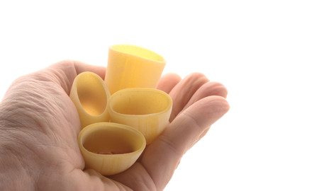 Pasta (Paccheri) are on one hand, isolated on whiteの写真素材