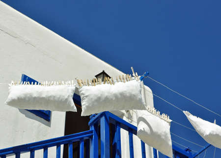 Hung with tongs caught in a balcony blue and whiteの写真素材