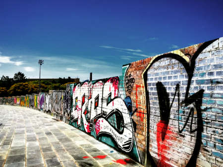 A long wall with graffiti in the cityのeditorial素材