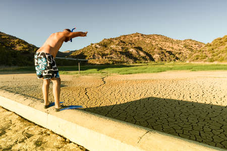 a boy with snorkel and fins in the fieldの写真素材