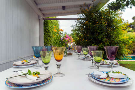 cutlery and table decorated with flowersの写真素材