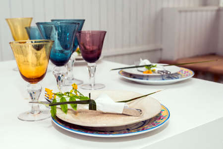 cutlery and table decorated with flowersの写真素材