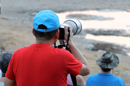 Photographer at the waterhole - Namibia Africa