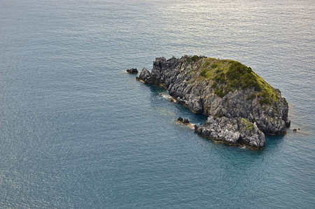 small island in front of italian coastlineの写真素材