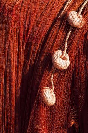 colored fishing net in a small harborの写真素材