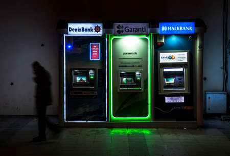 ISTANBUL, TURKEY - FEBRUARY 02  turkish man walking next to ATM in a street of the old dowtown on February 02, 2013 in Istanbul, Turkey のeditorial素材