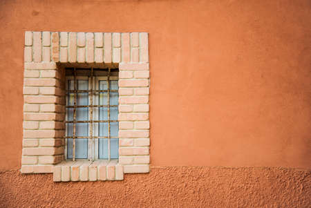italian window on the building with an orange wallの写真素材
