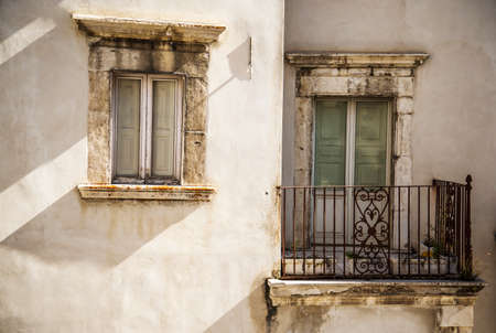 window and balcony on the building facade in Pescocostanzo, Italyの写真素材