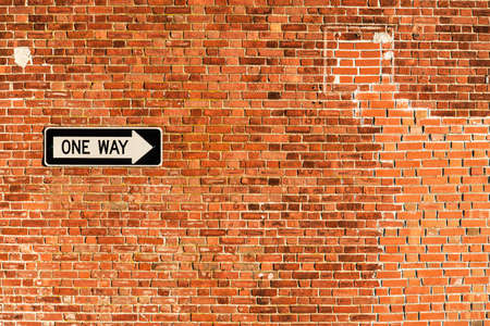 One way road signal on the wall in an american cityの写真素材