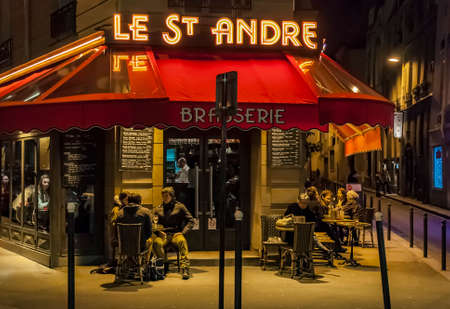 PARIS - MARCH 1: typical Paris cafe with people that enjoy dinner on March 1, 2014 in Paris, Franceのeditorial素材