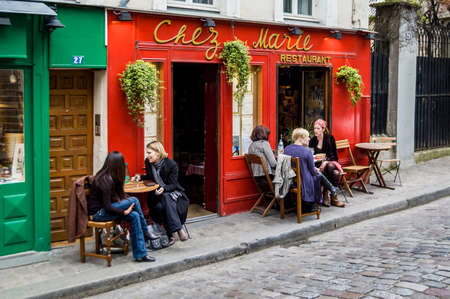 PARIS - MARCH 2: typical Paris cafe with people that enjoy dinner on March 2, 2014 in Paris, Franceのeditorial素材