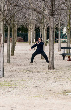 PARIS - MARCH 2: a man doing his exercise for oriental discipline in a park on March 2, 2014 in Paris Franceのeditorial素材