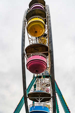 Ferris wheel on cloudy sky background vintage color