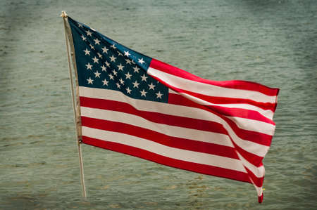 American flag with water on the backgroundの写真素材