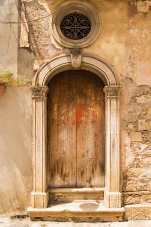 The entrance wooden door in an old Italian houseの写真素材