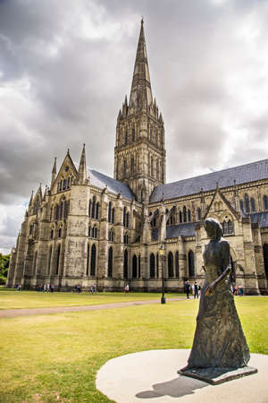 SALISBURY - JULY 17: the famous view of the Cathedral and park on sunny and cloudy day, on July 17, 2015 in Salisbury in South Englandのeditorial素材