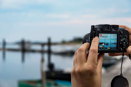Female hands taking a photo of landscapeの写真素材