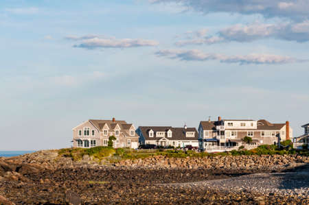 Houses near the coastline with blue and clean sky in Maine, USAの写真素材
