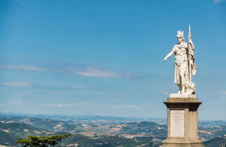 view of the ancient statue of liberty against the bright blue sky in San Marino Republicの写真素材
