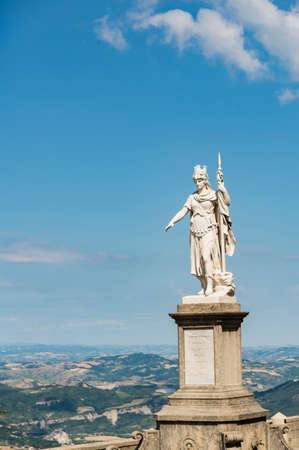 view of the ancient statue of liberty against the bright blue sky in San Marino Republicのeditorial素材